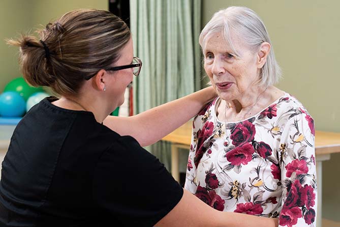 Female member of clinical staff working with patient