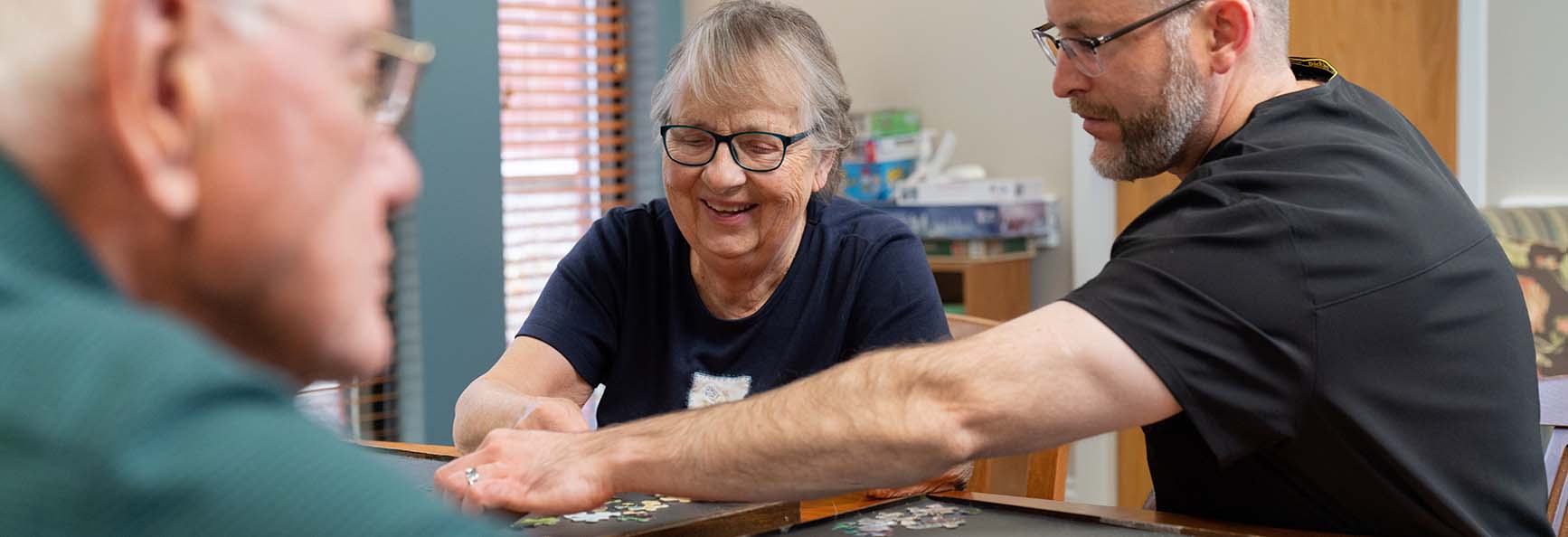 Smiling older female patient interacting with clinical staff