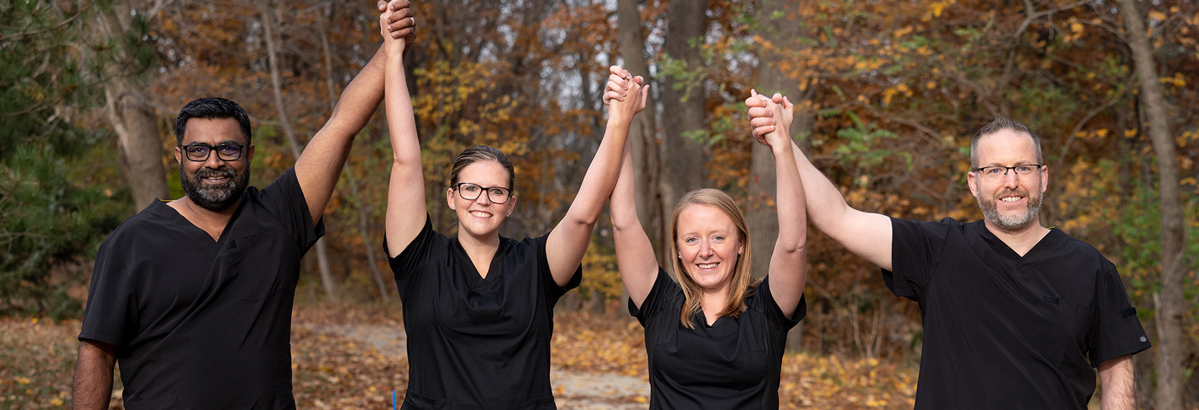 Clinical staff team with hands in air