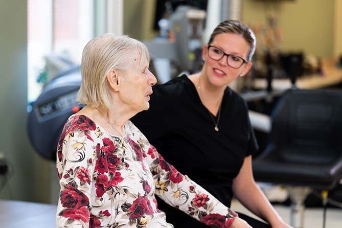 Nurse walking with patient in residential care hom