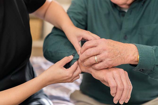 Nurse assists patient with forearm pain