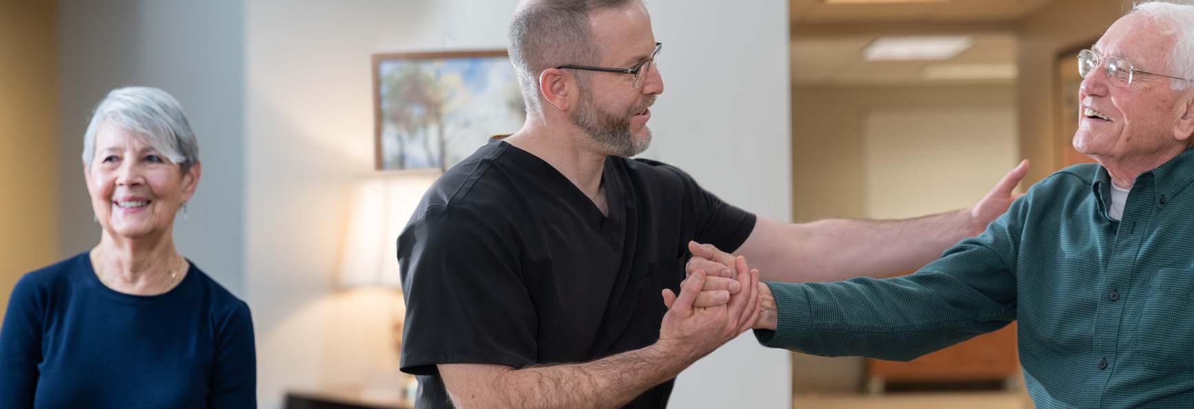 Older male patient interacting with clinical staff